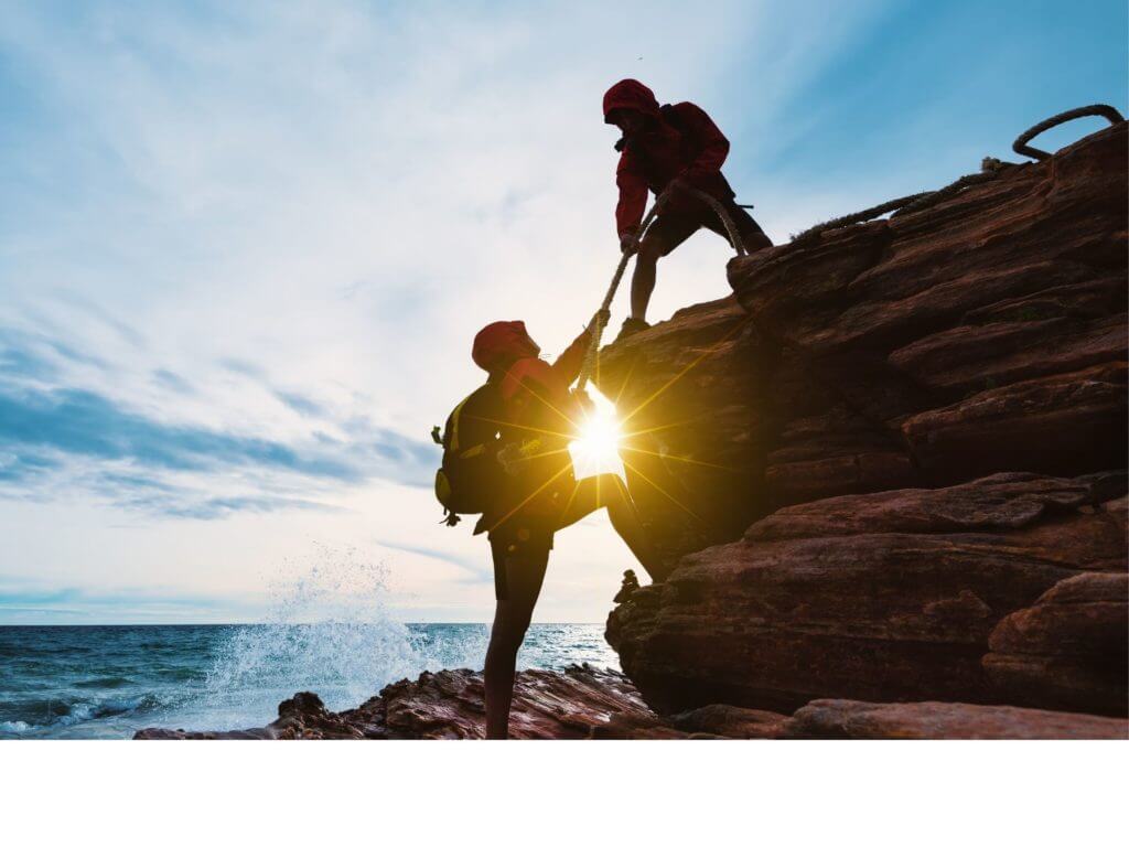 Climbers helping each other to illustrate Exam Preparation Group